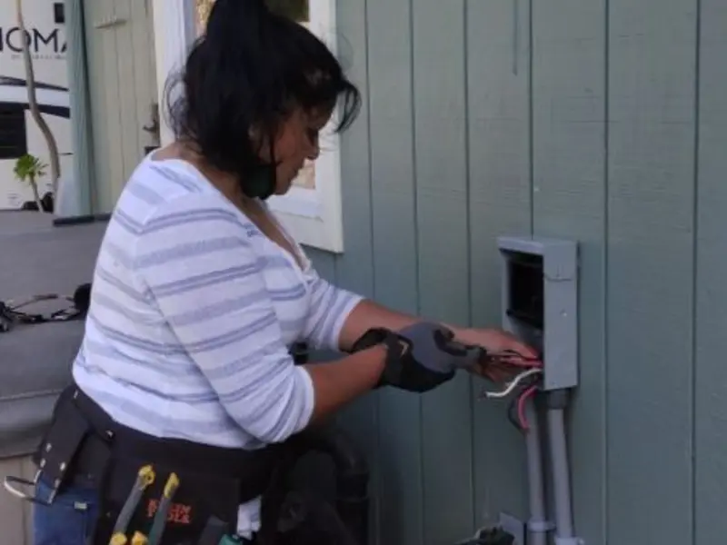 Licensed electrician wiring an exterior subpanel in Milliken